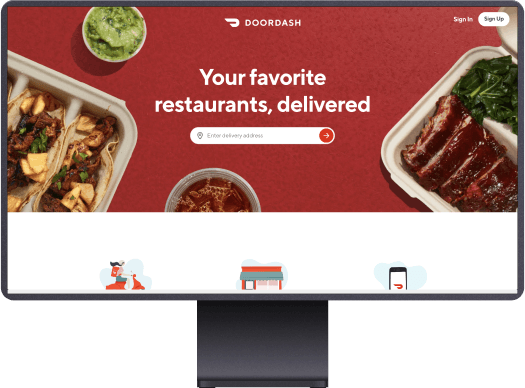 A monitor showing the Doordash homepage